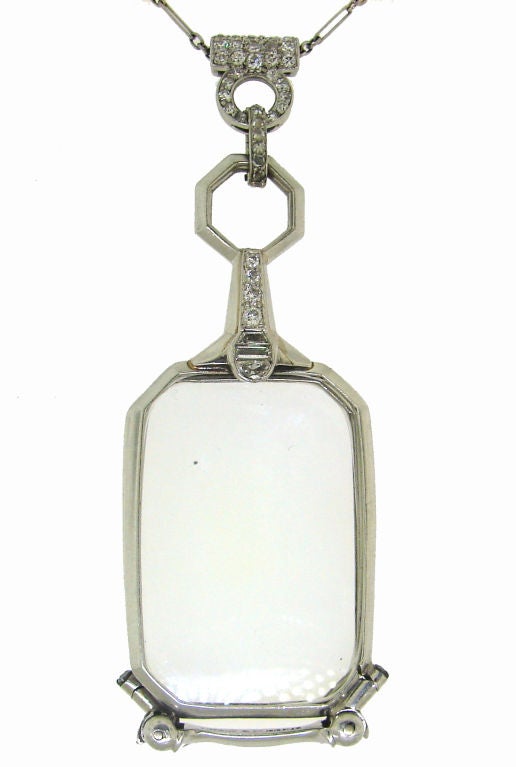 Classy Art Deco lorgnette created by Tiffany & Co. in the 1930's. It is made of platinum and set with different cut diamonds (round, baguette, half-moon and trapeze). The lorgnette opens up automatically when you press a button on the back. You can