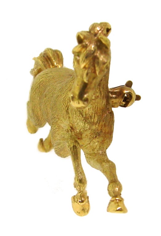 This gracious yellow gold pin was created by Tiffany & Co . It is made in the shape of a running horse. Posture and workmanship are outstanding. You can see every little detail: look at the horseshoes (pic.5)! <br />
There are seven hallmarks