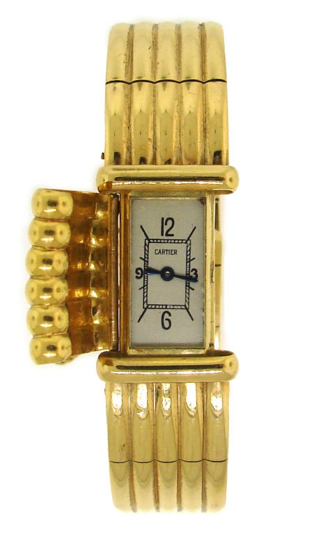 Rare (just few were made) vintage watch with a cover that turns the watch into a fashionable bracelet. Made of yellow gold. Has a safety chain. Serial # 78432. JAEGER-LE COULTRE movement.<br />
The bracelet / watch is slightly over 1/2