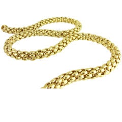 A necklace of gold woven, tublar links.