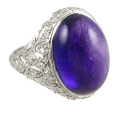 An Art Deco pave diamond and cabochon amethyst ring