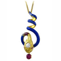 An antique snake pendant with blue enamelling and diamond head