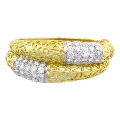 A gold double row cuff bracelet with pave diamond sections.