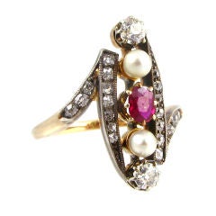 An antique gold and diamond ring with set pearls and ruby's.