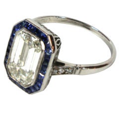 Emerald-cut diamond 
sapphire art deco ring