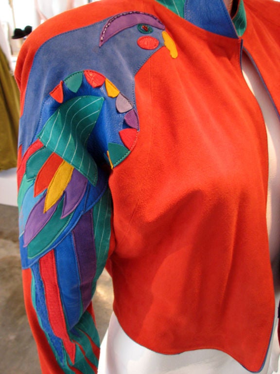 Fine vintage Gossamer Wings suede leather 'Parrot' bolero jacket. Authentic & oustanding Barbara Grimes 1980s item. Fine & supple multi-color suede applique item on true red suede background & blue leather trim. 'Parrot' single sleeve detail