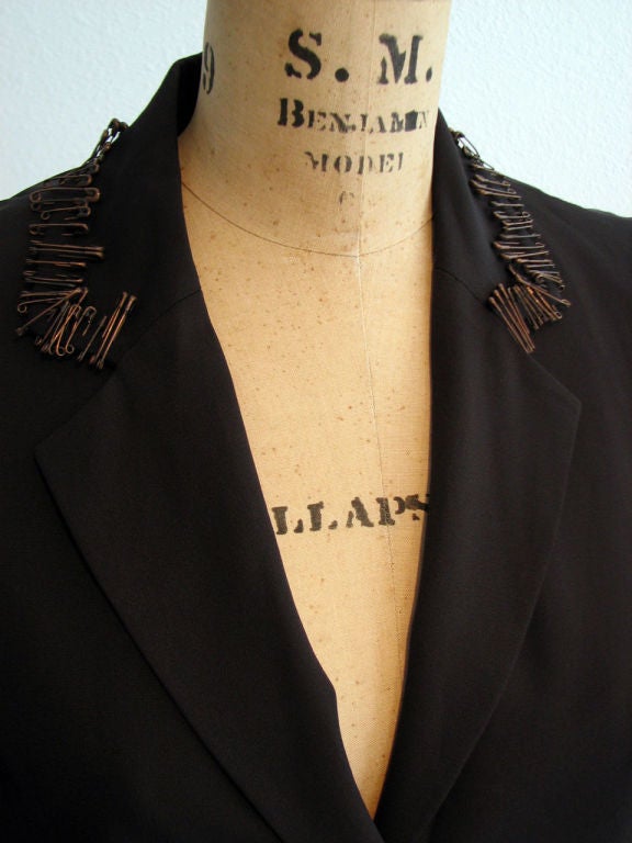 Fine & rare vintage Rifat Ozbek 'Safety Pin' trimmed sculpted jacket. Black super fine faille item features 'bronzed' safety pin trimmed lapel & sleeves with 2 button front. Item fully lined with vented back.