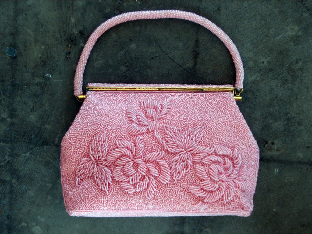 Fine vintage pink crystal encrusted hand bag. Authentic item fully satin lined with single open pocket. Item features gilt metal hardware & beaded 'fold-over' clasp/top closure. Beaded handle features a 5 1/2