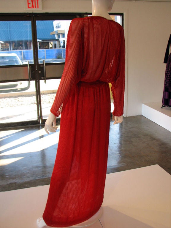 Fine & rare vintage Halston red crystal beaded silk gown & matching sash belt. Item labeled size 10 & appears to fit a modern US size 6. Vivid red silk chiffon item fully crystal bugle beaded. Gown features hook & snaps front closures. A rare item