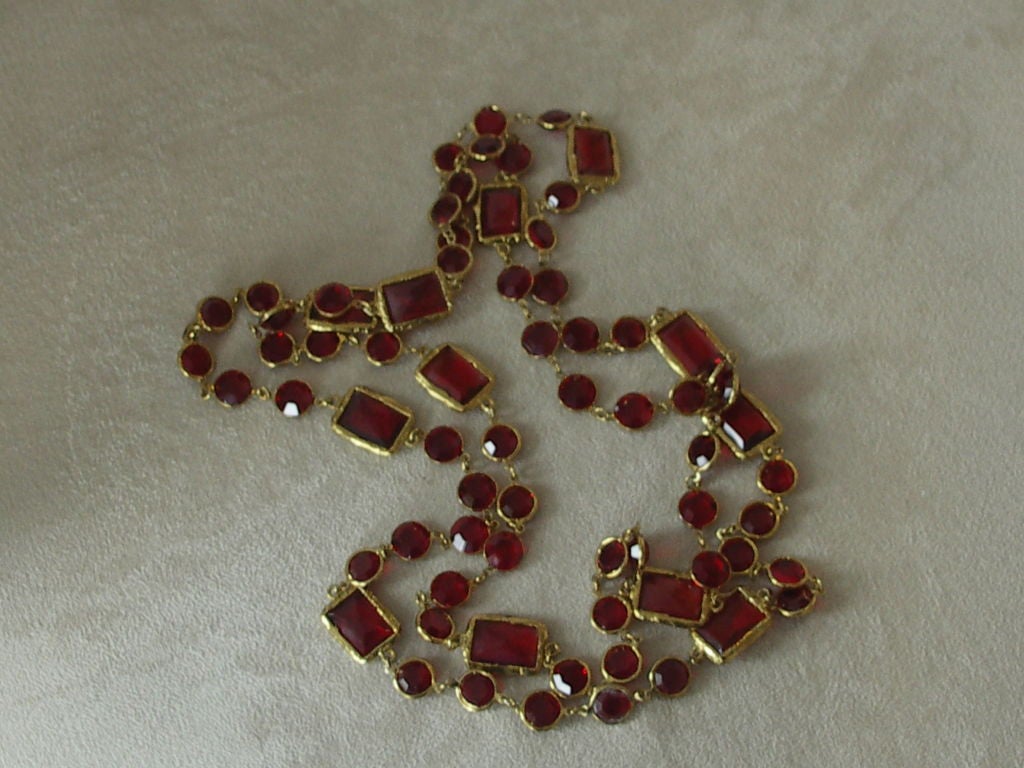 Rare red Chanel chiclet necklace comprising circular and rectangular red glass lozenzes in gold bezel work. The necklace measures 28 inches long- perfect for doubling or layering.