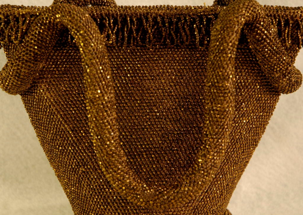 Featured is an excellent  copper  color sparkling beaded hand bag from the 1940's.  It is lined in satin and is very special indeed!<br />
 <br />
stands 7