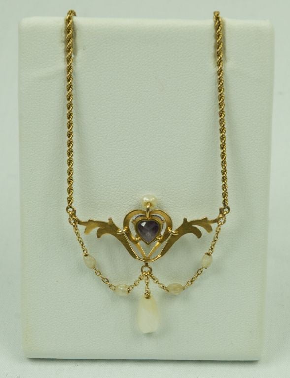 Featured is a  10K gold Victorian amethyst pearl lavalier.<br />
This is from the estate of an 88 year old woman native to San Francisco. She collected all her life.<br />
<br />
Please e-mail us with questions as our vintage and designer items