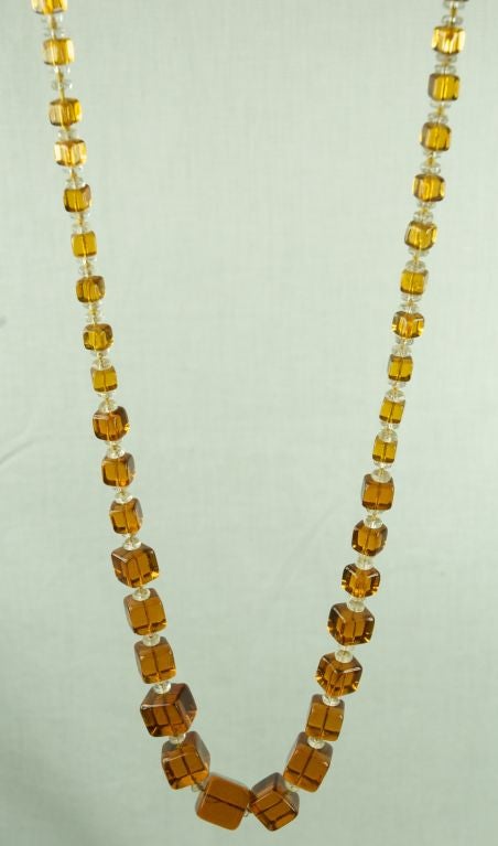 Featured is a fabulous 1930's flapper necklace made of square  graduated glass beads. It is long and very beautiful Excellent condition.

21