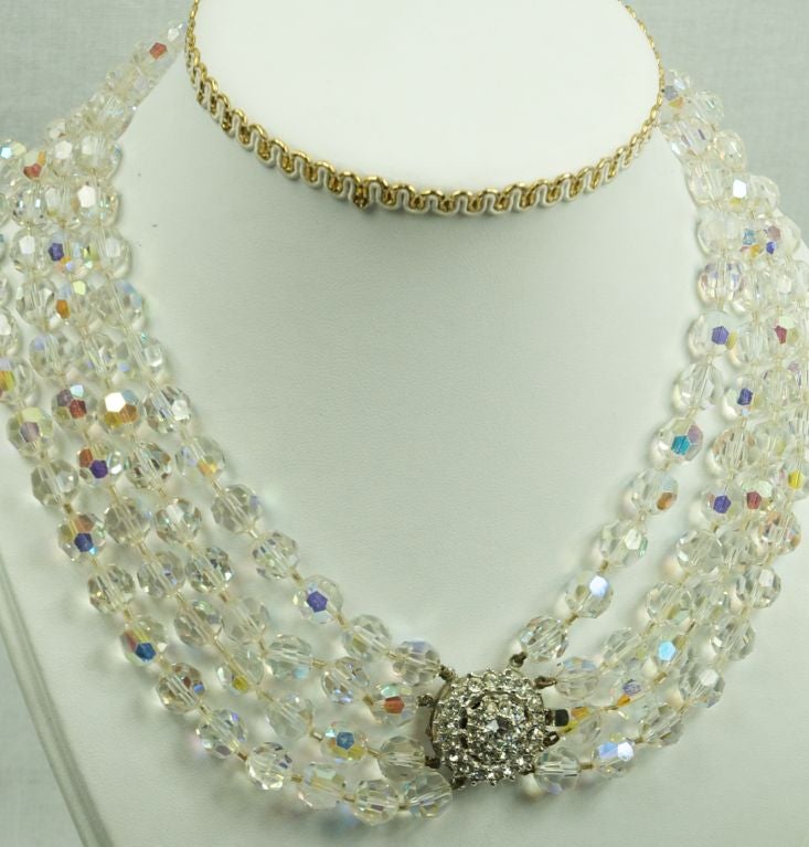 Featured is a fabulous 1950's four strand Austrian crystal necklace with large rhinestone clasp. This piece is gorgeous.<br />
Excellent condition.<br />
<br />
<br />
<br />
Please e-mail or call with questions as our vintage and designer
