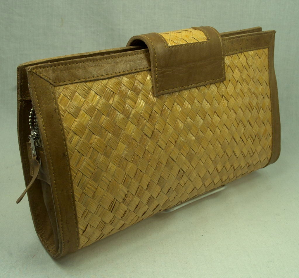 Featured for summer is a fantastic Joseph sea grass and leather clutch. It has metal zipper closure and pocket. Bamboo  closure. Label reads  Genuine leather made in Brazil. Excellent condition.<br />
<br />
Please e-mail or call us with questions
