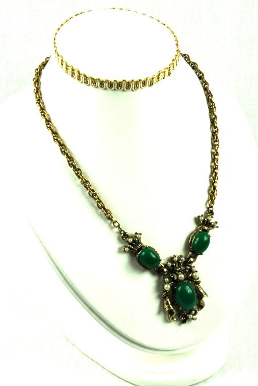 Featured is a gold tone jade lucite faux pearl ornate neckace from the 1940's. It is in excellent condition.<br />
<br />
Measurements:<br />
16