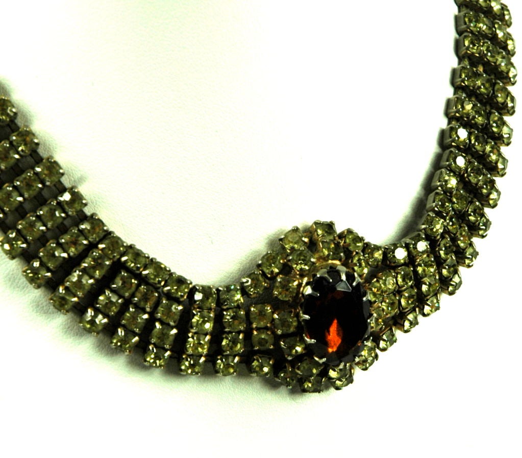 Featured is a fabulous choker of citron rhinestones and a big amber glass center.  The center is oval and the amber stone raised. Possible from Checz Republic. This is a very special piece. (The stone looks red in photo..however it is a rootbeer