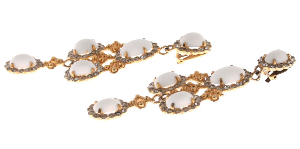 These are beautiful early KJL earrings, white glass surrounded by rhinestones.  They hang beautifully on the ear.