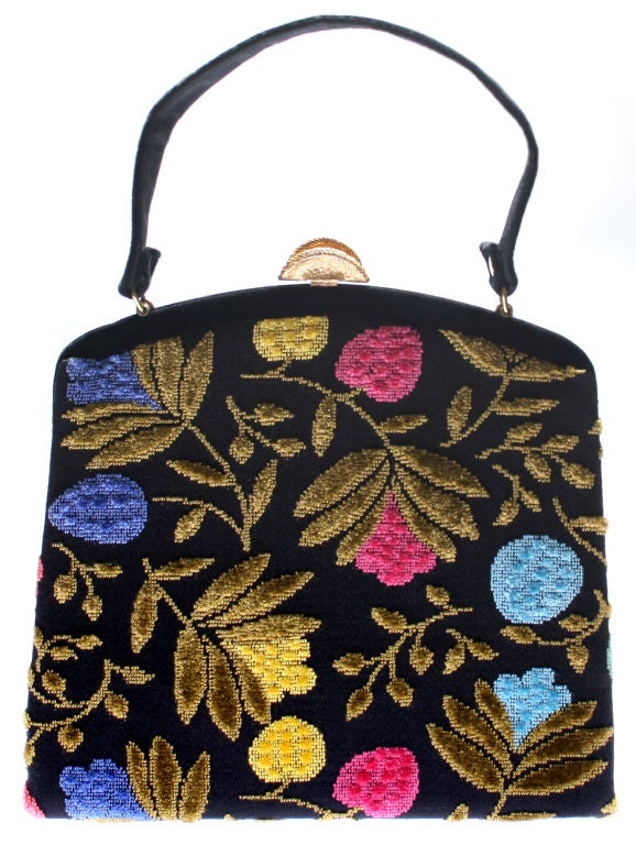 This is a fun handbag.  It measures 9 3/4 inches high x 9 3/4 inches wide and is 3 1/4 inches deep.<br />
The handle has a 4 1/4