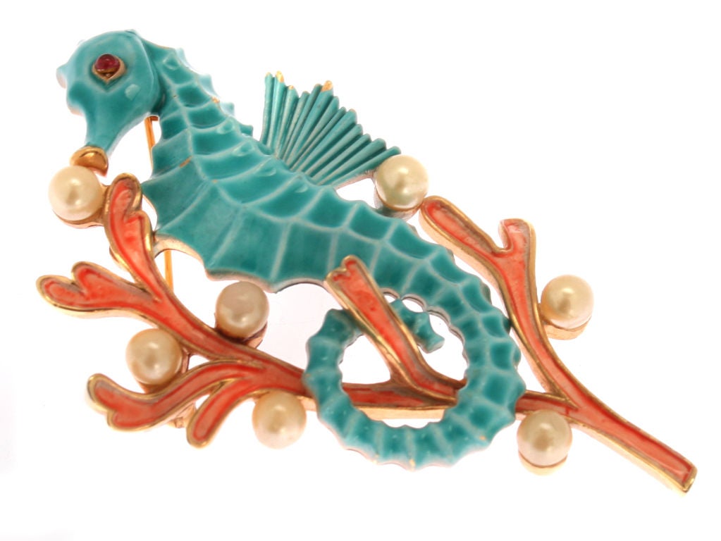 This is a great looking brooch of a seahorse resting on an enameled branch of coral with faux pearl air bubbles.