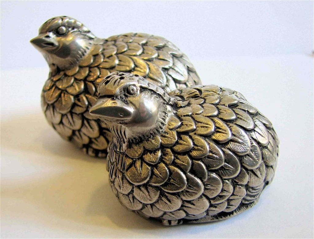 Set of solid pewter 'quail' salt and pepper shakers made by Gucci. The larger quail measures 3” L x 2 1/2’ H, and the smaller one measures 2 1/2” L x 2” H. Plastic stoppers on bottoms. Made in Italy. EXCELLENT/UNUSED CONDIITON.