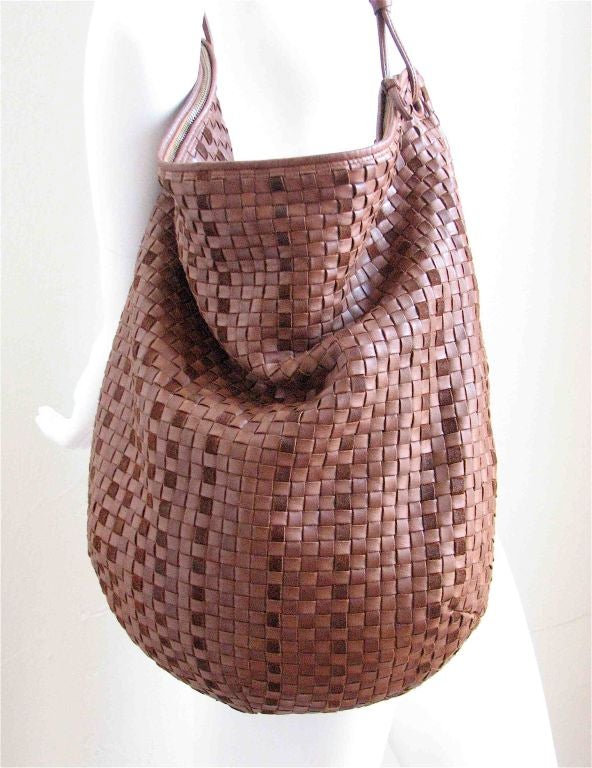 Light brown leather with darker brown suede accents. Zipper at top. Fully lined. One interior zippered pocket. 18