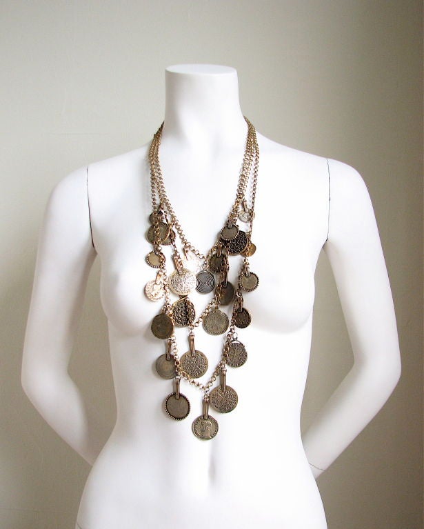 Stunning layered necklace from Yves Saint Laurent. 'Coins' are highly detailed and have a wonderful patina. Very dramatic. EXCELLENT if not perfect condition.
