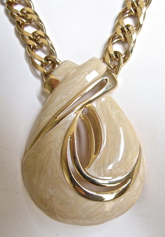 Uniquely shaped pendant on thick gold chain. Excellent condition.