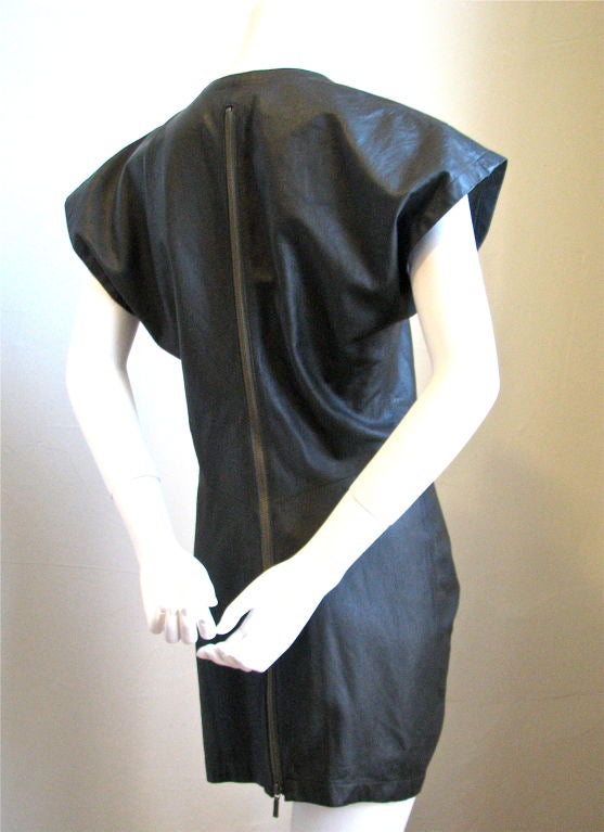Size 'M'.  Fits a US 2 to 6. Zips up top portion of front and entire back. Wonderful drape/twist detail at waistline. Color is green/gray tone. Made of the softest sheep skin imaginable. A very rare and excellent example of Miyake's early work.
