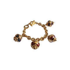 YVES SAINT LAURENT gilt & enameled bracelet with oriental charms