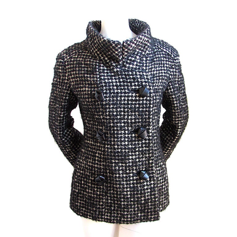Gorgeous houndstooth wool/mohair jacket with very unique 'knotted' black leather buttons from Galanos dating to the 1960's. Jet black and off white fuzzy wool. Stand up collar.  Hidden pockets at hips. Fully lined. Fits a US size 4-6. Approximate