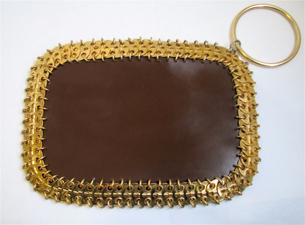 Very rare Rabanne purse!  This one is made of rich, smooth brown leather with gold metal disc trim. Zipper entry.  Strap intended to be worn as a bracelet. Made in Italy.  9.75