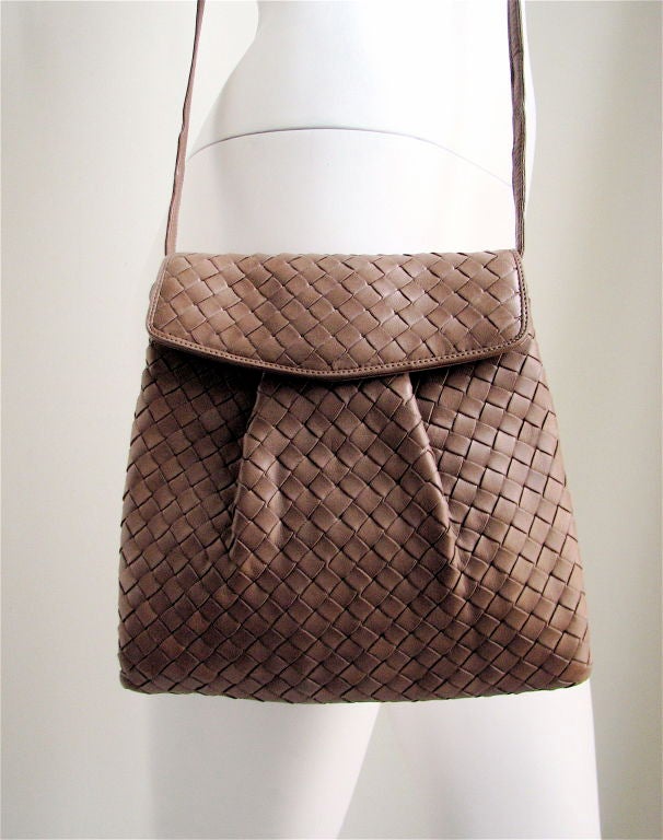 Beautiful taupe woven leather purse from Bottega Veneta. Butter soft leather. Strap can be removed to use this as a clutch. Fully lined in brown. One interior zippered compartment. Snap closure. Measures 9.25