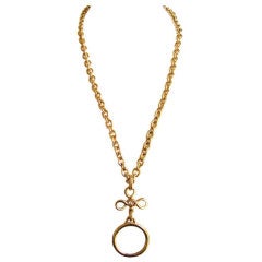 CHANEL extra long gold necklace with magnifying glass pendant