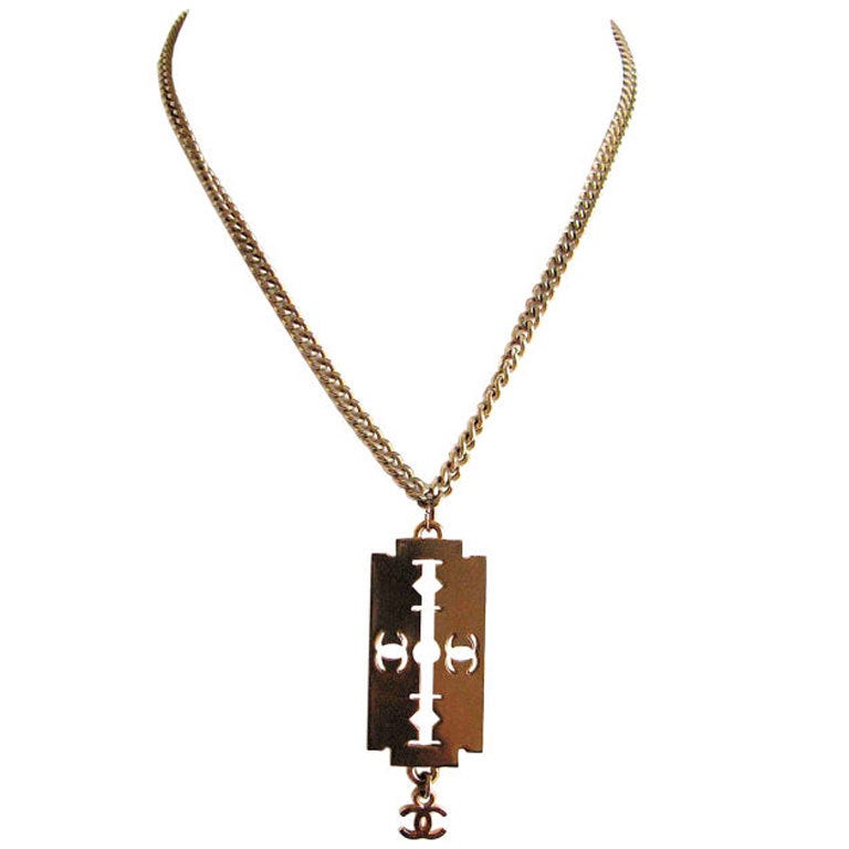 CHANEL gold 'razor blade' necklace with CC charm at 1stDibs gold razor blade necklace, gold razor blade pendant, chanel blade