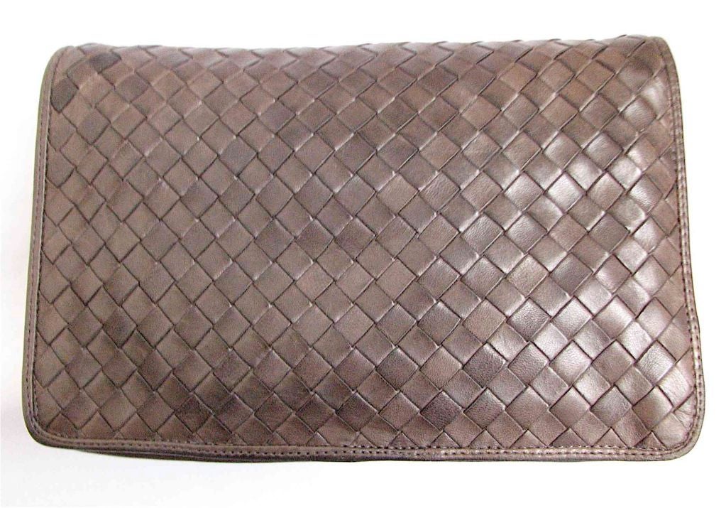 Gorgeous woven leather bag from Bottega Veneta. Softest leather ever. Clutch includes very long, thin strap that can be tucked in or removed all together. One zippered compartment. Fully lined.  Made in Italy. Measures approximatley 9