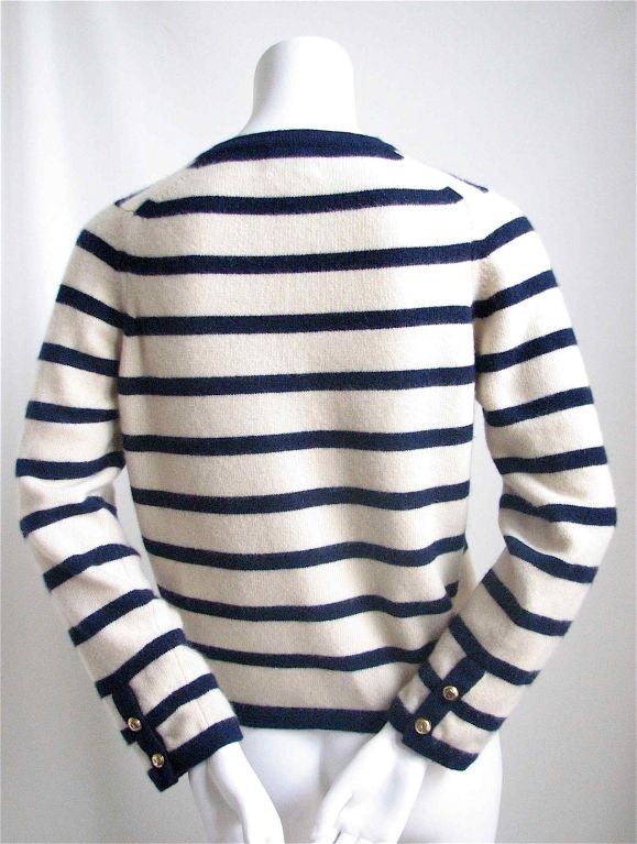 Incredibly soft and fuzzy nautical cardigan from Chanel. Deep navy blue and cream. 11 large 'CC' glt buttons. Two breast pockets. Cashmere.  Size S/M Approximate measurements are:  38