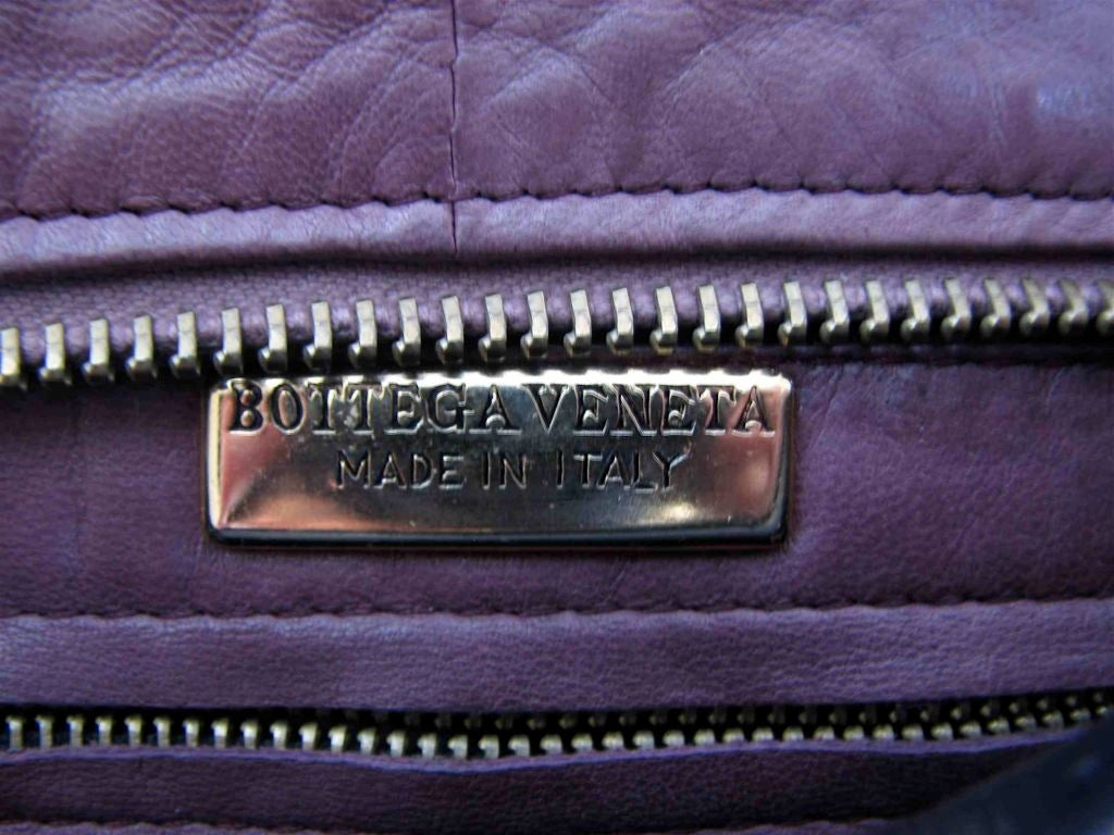BOTTEGA VENETA plum woven leather clutch with tassel 1