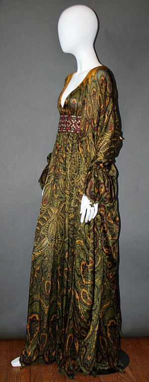 This incredibly rare and incredible gown hails from one of ALEXANDER MCQUEEN's last collections. A stunning silk dress with tones and hues of chartreuse, gold, burgundy, navy and olive green in an exotic Hindu-inspired paisley and damask print with