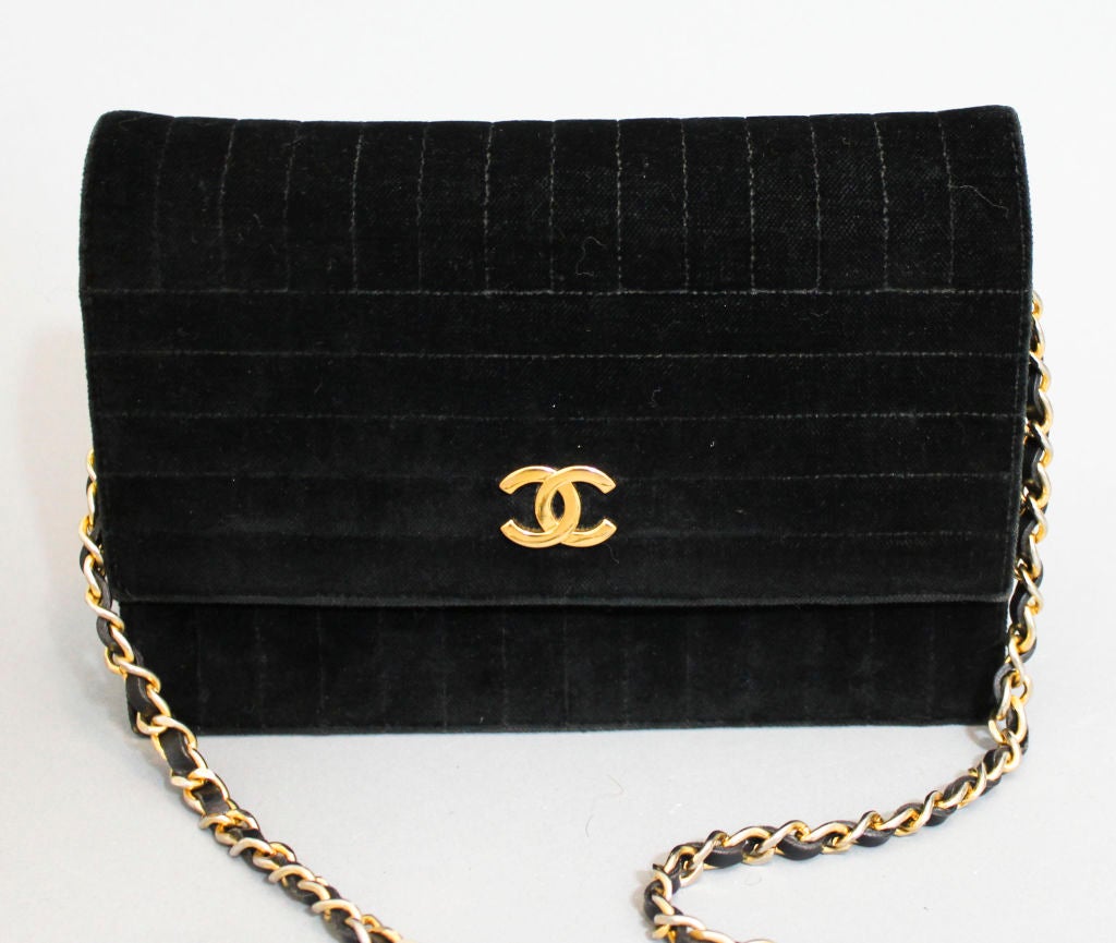 Vintage Chanel Black Stitched Velvet Evening Bag with leather and goldtone chain strap and goldtone interlock logo clasp. Black grosgrain interior with zip pocket and logo-embossed zipper pull. Original box and dustbag included.  <br />
<br