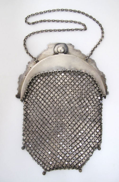 Victorian sterling silver mesh evening bag with ornate paisley filigree clasp and chain handle.  In excellent condition, this piece is as relevant today as it was a century ago.  <br />
<br />
Length: 7