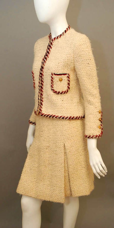 This is THE ultimate find for any Chanel collector: a true piece of gorgeous vintage haute couture. From the style and structure of the piece, we believe it to be from a 1980s couture collection. This spectacular skirt suit was fitted and tailored