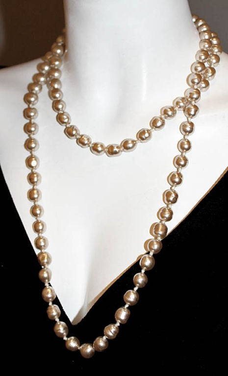 This gorgeous CHANEL necklace is truly a vintage gem. Designed in 1981, this amazing sautoir is a timeless and classic accessory. Lovely worn long or doubled around the neck. Comprised of Gripoix glass stones coated with pink, pearly enamel