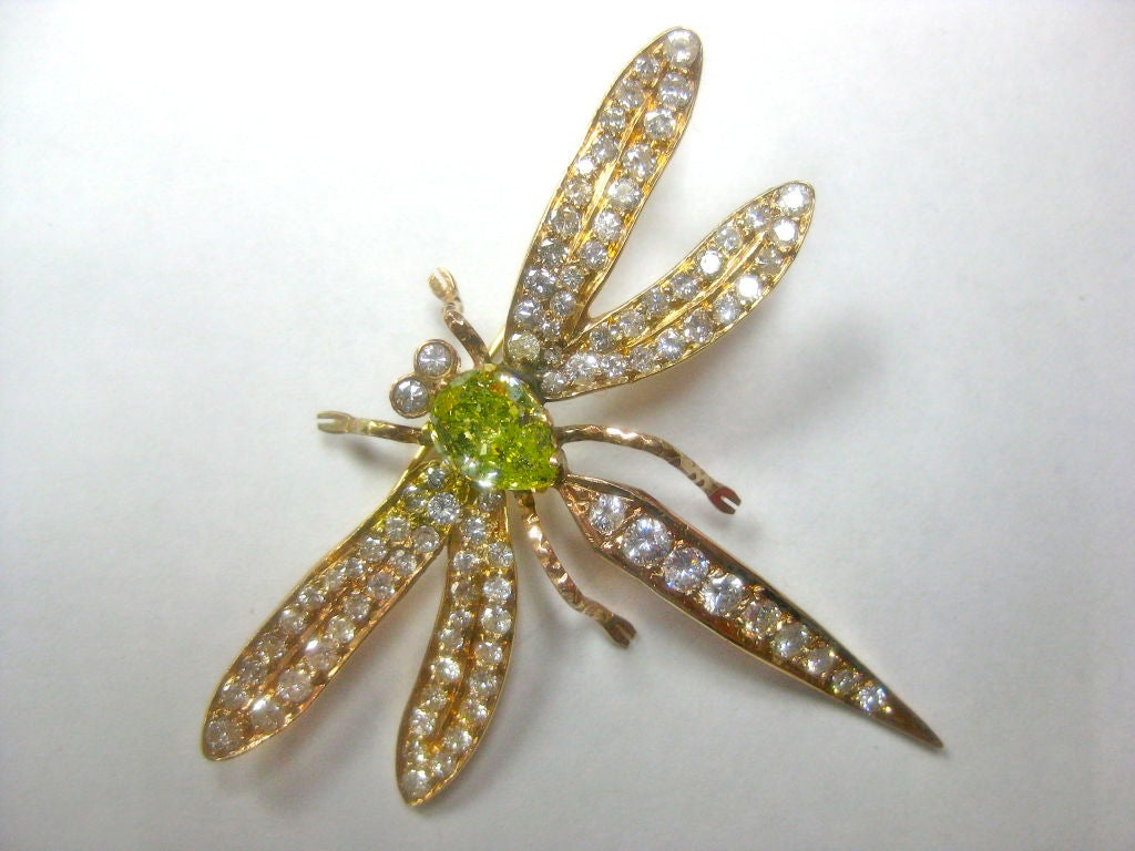 18kt yellow gold dragonfly pin set with 92 diamonds totaling approximately 3.00 carats.  The body is set with a 1.81 Natural Fancy Intense Green-Yellow GIA certified diamond.