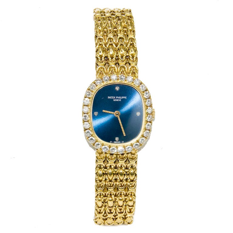 Ladies Patek Philippe, Ellipse, signed Case, Movement and integrated link Bracelet. Blue dial with Diamond Markers, Dimonds set around Bezel totals 1.10 Carat. Quartz Movement.