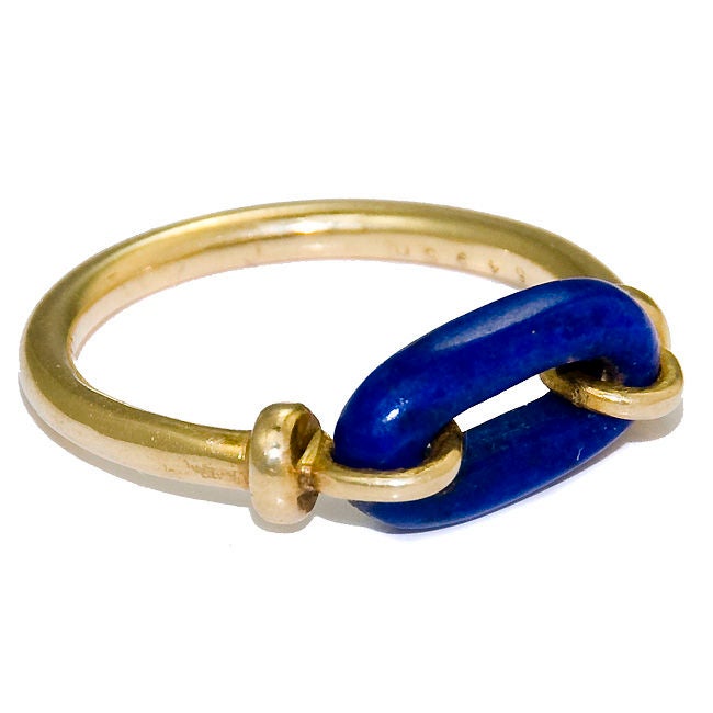 Lovely Cartier ring of 18K yellow gold and Blue Lapis, Signed and Numbered. Lapis Link measures 1/2 inch. Shank is 1/16 inch thick.