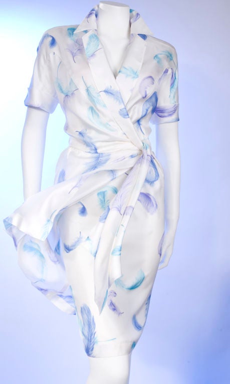 Early 90’s Thierry Mugler Silk Wrap Dress.<br />
White silk with turquoise, blue and purple feather design.<br />
The pencil skirt closure is on the right hip and the wrap snap closure is on the left hip.<br />
<br />
The original size label is