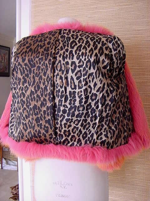 Short, shaped almost like a shrug.....  
Cut narrow through the shoulder with a 3/4 sleeve.  
The color is drop dead sensational! 
JACK NICKELSON TRIED TO RIP THIS FAB FUR OUT OF MY HANDS AT A BEVERLY HILLS BOUTIQUE TO PURCHASE FOR HIS