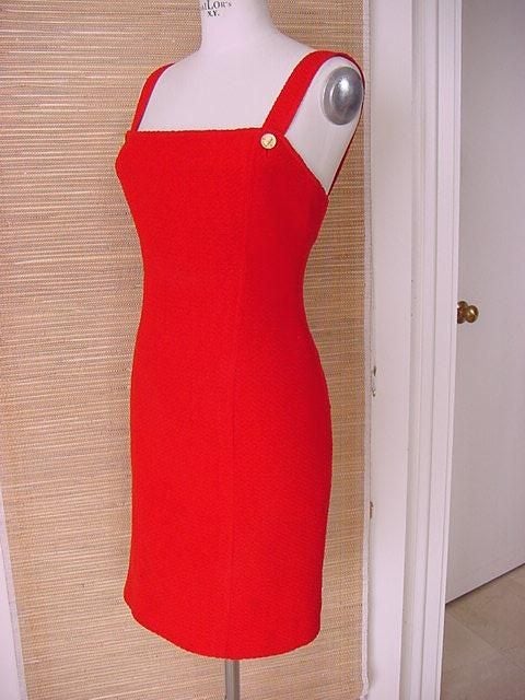 Every lady in town was lined up on a waiting list for this jacket and dress combo witch at the time also came in navy blue.<br />
But we al bought the red!<br />
The straps attach with a working button in the front and the rear.<br />
Gold
