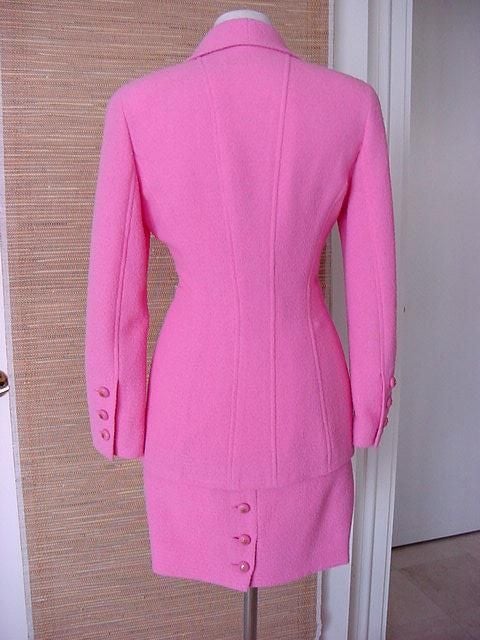 DIVINE!!!!! FABULOUS PINK CHANEL boucle suit that is, of course, a classic forever beauty!<br />
Beautifully shaped jacket.<br />
Rounded lapels that have the effect of a scalloped edge.<br />
4 Pocket, 4 button single breasted jacket.<br